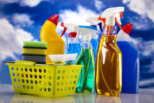 Person treating a fresh stain on fabric with cleaning solution